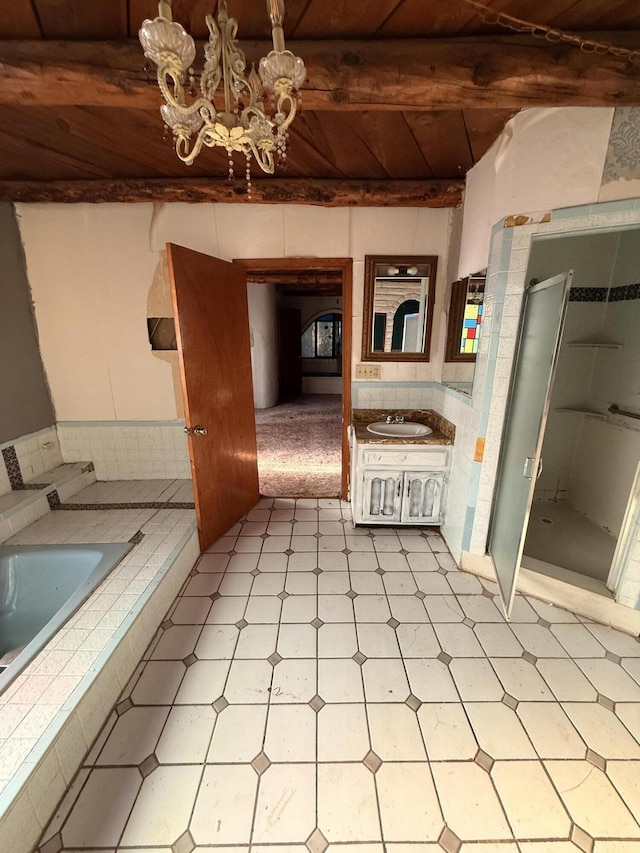 1233 Montrose Pl SW, Albuquerque, NM 87105 - full bath featuring tile patterned floors, a stall shower, a chandelier, vanity, and tiled bath