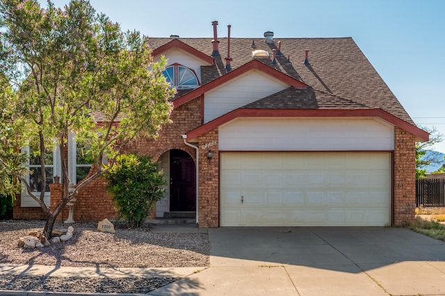 7316 Portulaca Dr NW, Albuquerque, NM 87120 - view of front of house with brick siding, concrete driveway, a garage, and roof with shingles