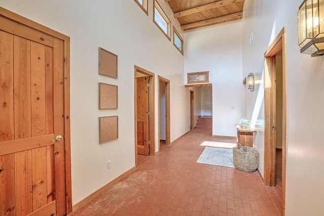 78 Quirks Ln, Corrales, NM 87048 - hall with a wooden ceiling with exposed beams, brick flooring, and a high ceiling