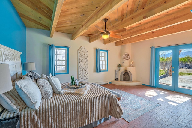 78 Quirks Ln, Corrales, NM 87048 - bedroom with access to outside, french doors, multiple windows, a wooden ceiling with exposed beams, and a fireplace with raised hearth
