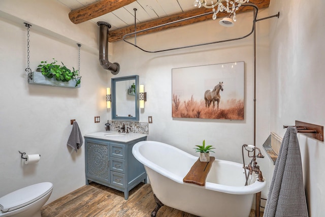 78 Quirks Ln, Corrales, NM 87048 - full bath featuring vanity, a freestanding bath, wood finished floors, beam ceiling, and a chandelier