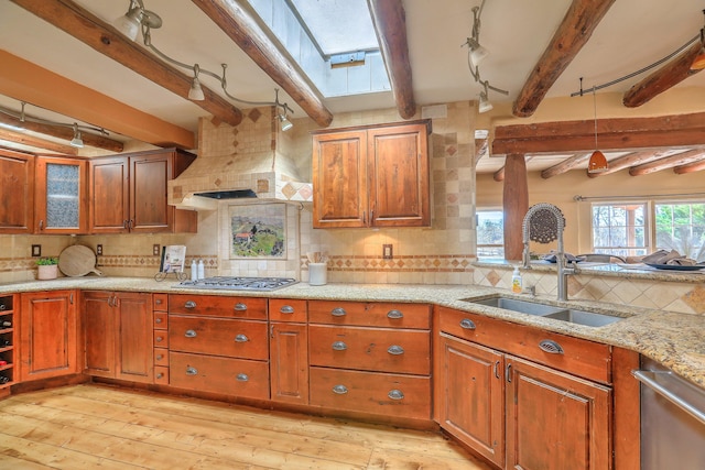 78 Quirks Ln, Corrales, NM 87048 - kitchen featuring a skylight, beam ceiling, appliances with stainless steel finishes, and brown cabinets