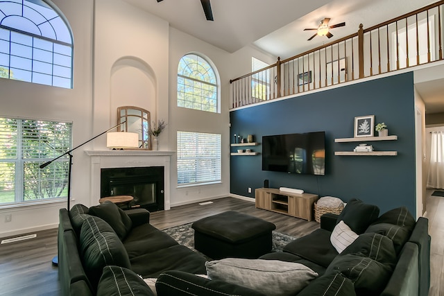 6109 Chamblee Ct NE, Albuquerque, NM 87111 - living area with ceiling fan, a towering ceiling, a glass covered fireplace, and wood finished floors