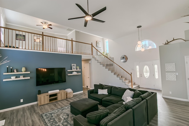 6109 Chamblee Ct NE, Albuquerque, NM 87111 - living room with high vaulted ceiling, ceiling fan, stairway, wood finished floors, and crown molding