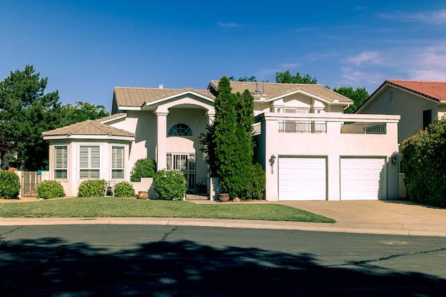 6109 Chamblee Ct NE, Albuquerque, NM 87111 - mediterranean / spanish-style home featuring a balcony, a tiled roof, stucco siding, driveway, and an attached garage