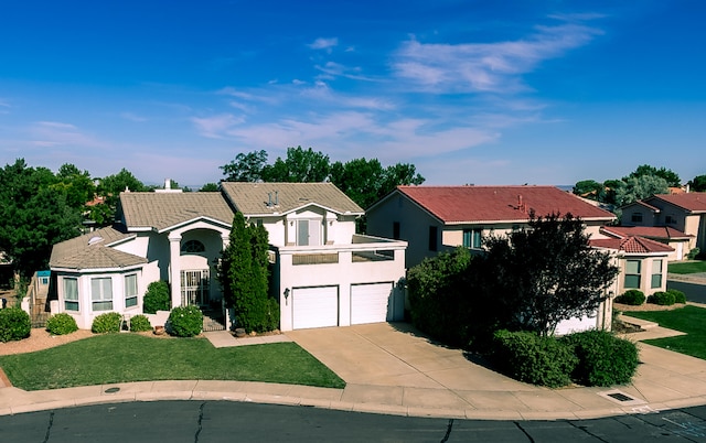 6109 Chamblee Ct NE, Albuquerque, NM 87111 - view of front of house featuring concrete driveway, a garage, stucco siding, a front yard, and a tile roof