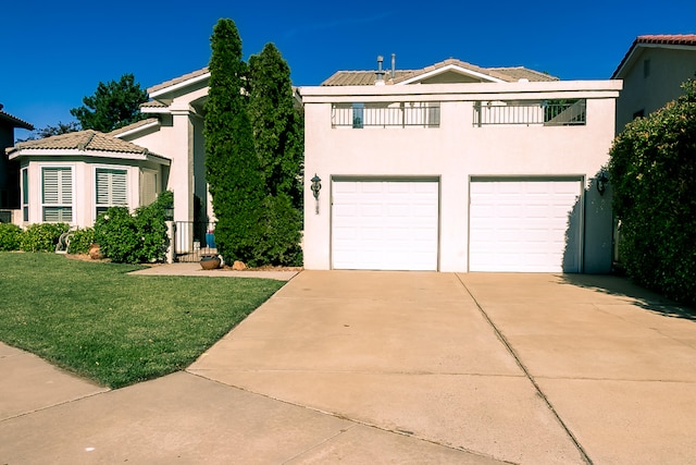 6109 Chamblee Ct NE, Albuquerque, NM 87111 - view of front facade featuring a garage, driveway, a front lawn, and stucco siding