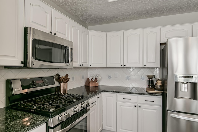 6109 Chamblee Ct NE, Albuquerque, NM 87111 - kitchen with appliances with stainless steel finishes, white cabinetry, and a textured ceiling
