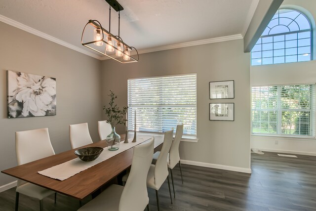 6109 Chamblee Ct NE, Albuquerque, NM 87111 - dining area with dark wood-style flooring, crown molding, and a chandelier