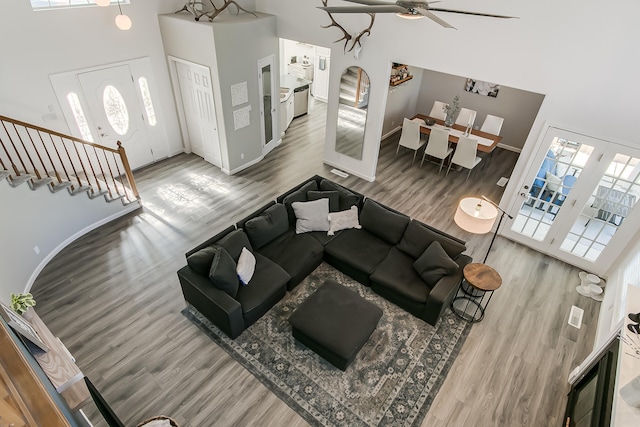 6109 Chamblee Ct NE, Albuquerque, NM 87111 - living area with a towering ceiling, wood finished floors, ceiling fan, and stairway