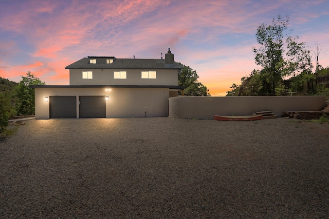 7 Corte De Canoncito, Cedar Crest, NM 87008 - view of front of property with stucco siding, a chimney, driveway, a garage, and a metal roof