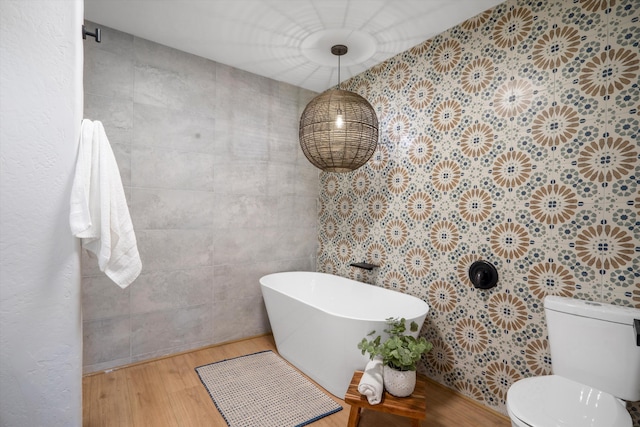 7 Corte De Canoncito, Cedar Crest, NM 87008 - full bathroom featuring wood finished floors, a freestanding tub, and tile walls