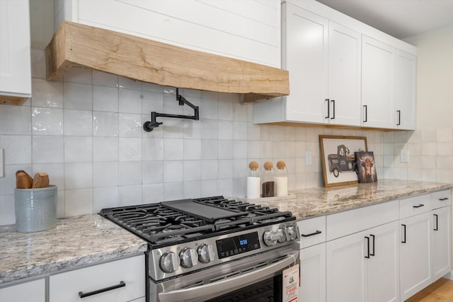 7 Corte De Canoncito, Cedar Crest, NM 87008 - kitchen featuring stainless steel gas stove, decorative backsplash, white cabinetry, and light stone counters