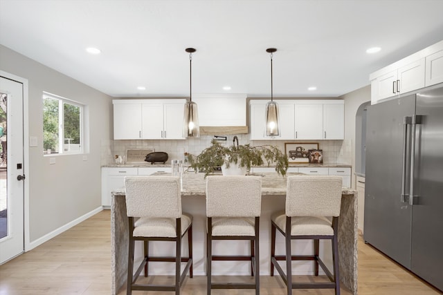 7 Corte De Canoncito, Cedar Crest, NM 87008 - kitchen with high end fridge, tasteful backsplash, light wood-style flooring, light stone countertops, and recessed lighting