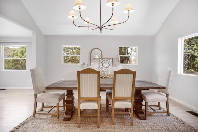 7 Corte De Canoncito, Cedar Crest, NM 87008 - dining area with vaulted ceiling, a chandelier, plenty of natural light, and light wood finished floors