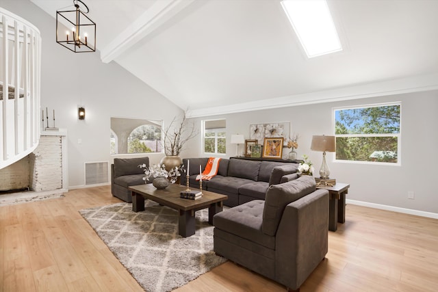 7 Corte De Canoncito, Cedar Crest, NM 87008 - living area featuring high vaulted ceiling, beamed ceiling, a chandelier, and light wood-type flooring