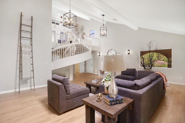 7 Corte De Canoncito, Cedar Crest, NM 87008 - living area with a chandelier, light wood finished floors, beam ceiling, stairway, and healthy amount of natural light