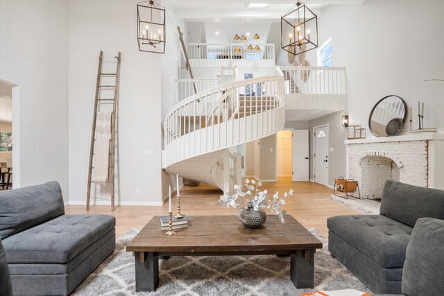 7 Corte De Canoncito, Cedar Crest, NM 87008 - living area featuring a chandelier, a towering ceiling, wood finished floors, and plenty of natural light