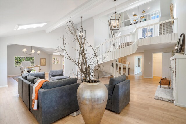 7 Corte De Canoncito, Cedar Crest, NM 87008 - living area with a chandelier, stairs, beam ceiling, wood finished floors, and high vaulted ceiling