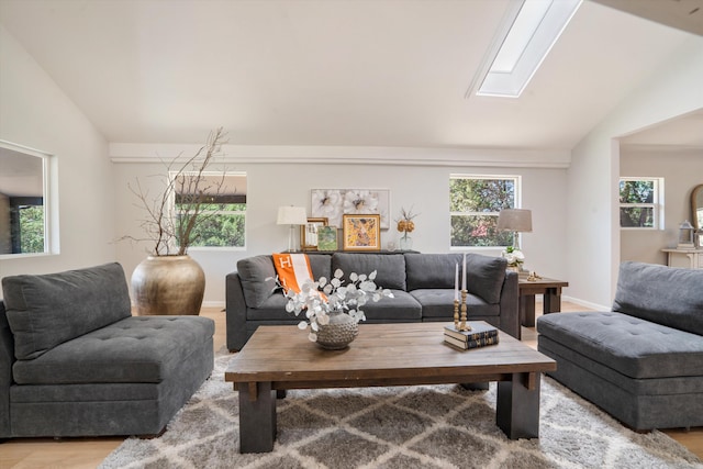 7 Corte De Canoncito, Cedar Crest, NM 87008 - living room with vaulted ceiling, a skylight, and light wood-style flooring