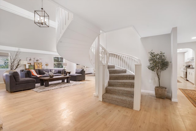 7 Corte De Canoncito, Cedar Crest, NM 87008 - living area with stairway, light wood-style flooring, and a chandelier