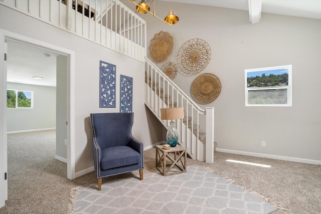 7 Corte De Canoncito, Cedar Crest, NM 87008 - sitting room with carpet flooring, stairway, beamed ceiling, and a towering ceiling