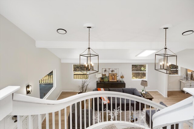 7 Corte De Canoncito, Cedar Crest, NM 87008 - stairs featuring a chandelier, wood finished floors, and beam ceiling