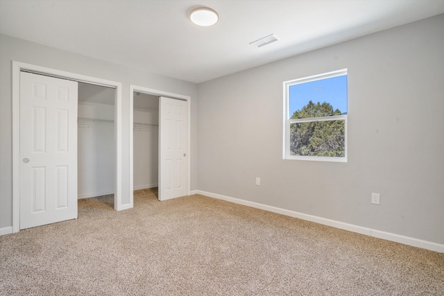 7 Corte De Canoncito, Cedar Crest, NM 87008 - unfurnished bedroom with two closets and light carpet