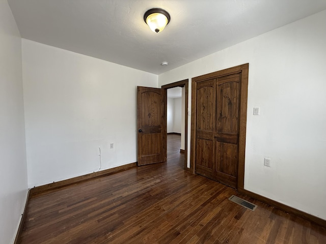 98 Rancho Pequenos Way, Albuquerque, NM 87114 - unfurnished bedroom featuring dark wood-style floors and baseboards