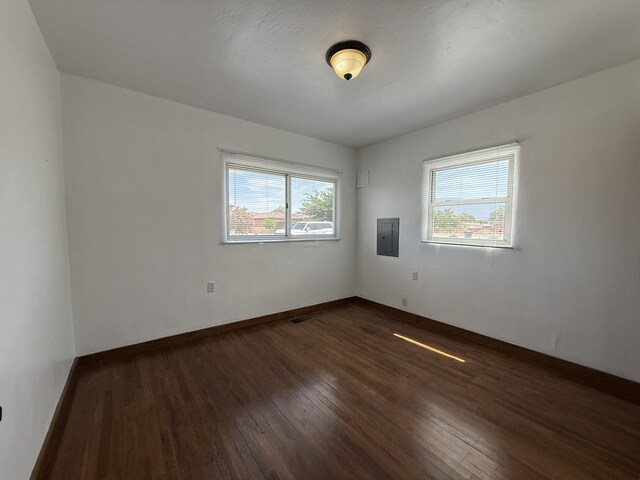 98 Rancho Pequenos Way, Albuquerque, NM 87114 - empty room with plenty of natural light, dark wood finished floors, and electric panel