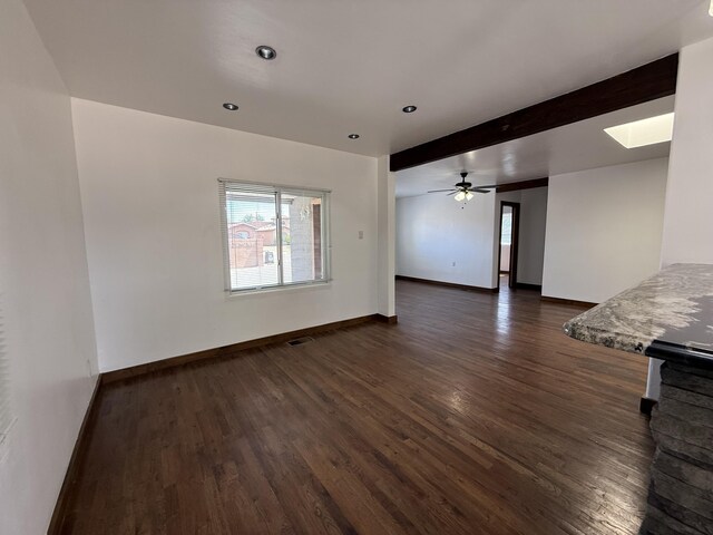 98 Rancho Pequenos Way, Albuquerque, NM 87114 - unfurnished room with dark wood-type flooring, a skylight, beam ceiling, ceiling fan, and recessed lighting