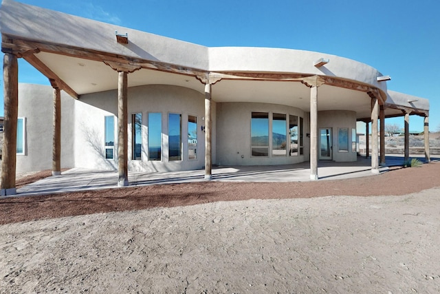3 Quiet Ln, Corrales, NM 87048 - back of property with stucco siding and a patio