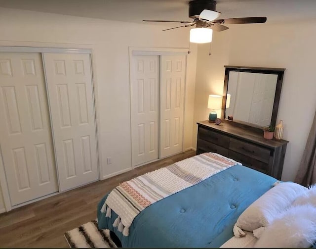 4601 Carlisle Blvd NE Unit H-2, Albuquerque, NM 87109 - bedroom featuring two closets, wood finished floors, and a ceiling fan