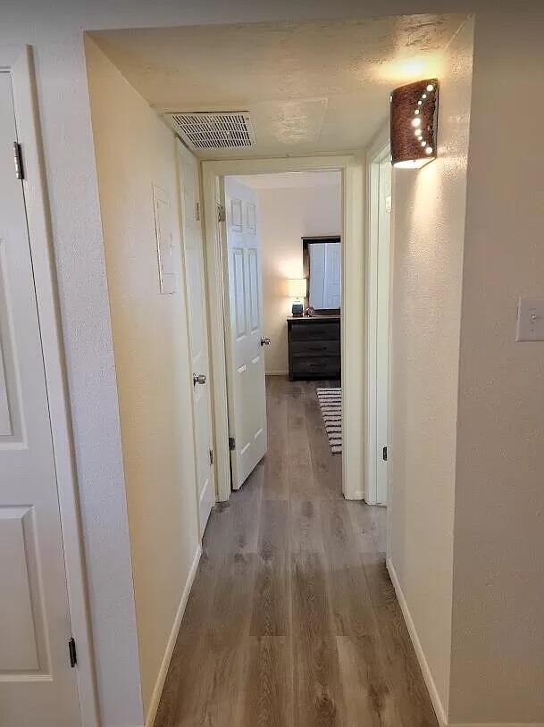 4601 Carlisle Blvd NE Unit H-2, Albuquerque, NM 87109 - hallway with wood finished floors and baseboards