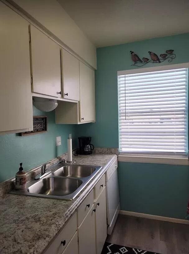 4601 Carlisle Blvd NE Unit H-2, Albuquerque, NM 87109 - kitchen with white cabinetry, white dishwasher, and light wood-style floors