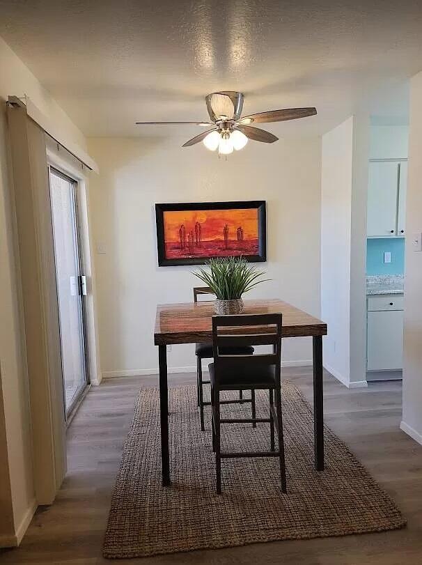 4601 Carlisle Blvd NE Unit H-2, Albuquerque, NM 87109 - dining area with wood finished floors and ceiling fan