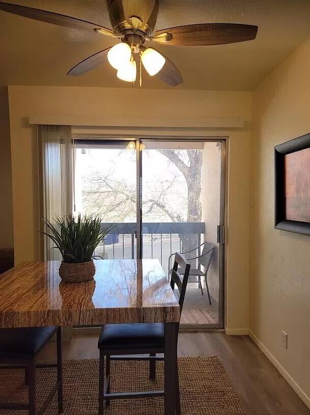 4601 Carlisle Blvd NE Unit H-2, Albuquerque, NM 87109 - dining space featuring plenty of natural light, ceiling fan, and wood finished floors