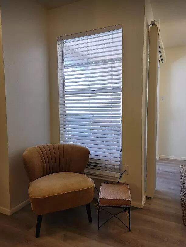 4601 Carlisle Blvd NE Unit H-2, Albuquerque, NM 87109 - sitting room with baseboards and wood finished floors