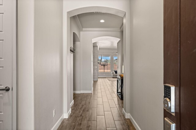 6873 Cleary Loop NE, Rio Rancho, NM 87144 - hall featuring ornamental molding, arched walkways, and dark wood finished floors