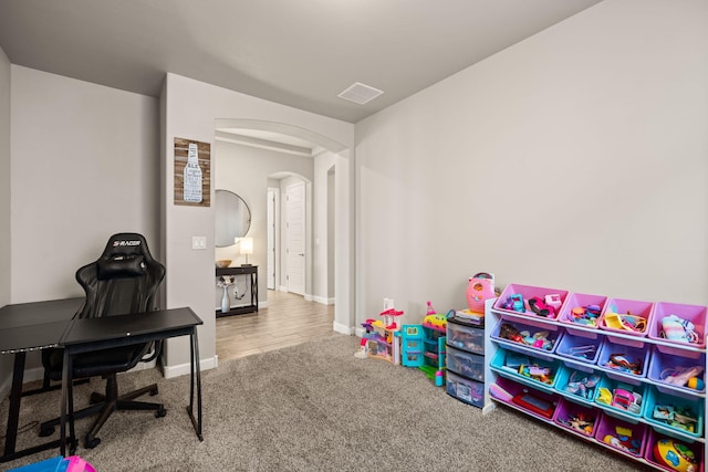 6873 Cleary Loop NE, Rio Rancho, NM 87144 - rec room featuring arched walkways, carpet flooring, and an office area