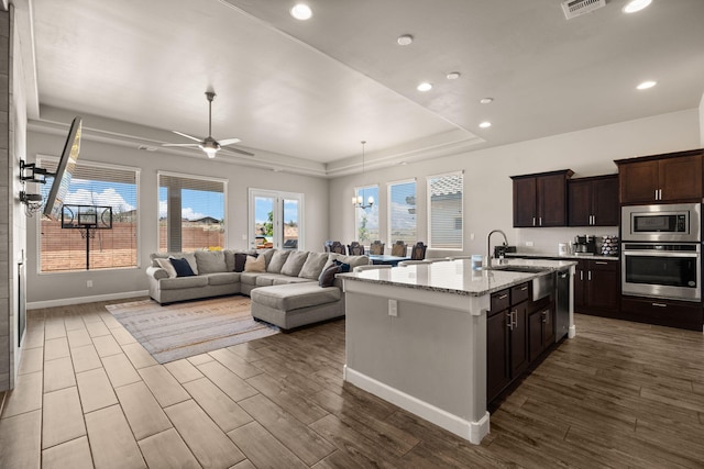 6873 Cleary Loop NE, Rio Rancho, NM 87144 - kitchen with appliances with stainless steel finishes, dark wood-type flooring, recessed lighting, dark brown cabinetry, and ceiling fan