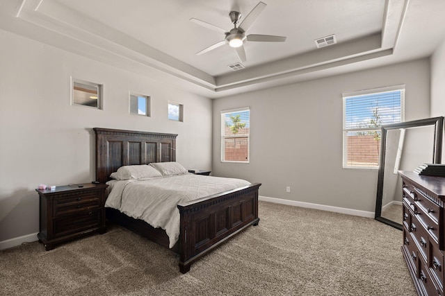 6873 Cleary Loop NE, Rio Rancho, NM 87144 - bedroom featuring a tray ceiling, light colored carpet, and a ceiling fan