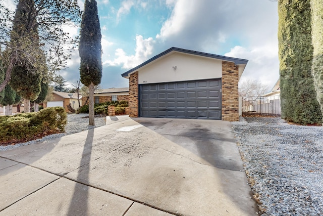 4807 Parsifal St NE, Albuquerque, NM 87111 - view of front of home featuring brick siding, stucco siding, and concrete driveway