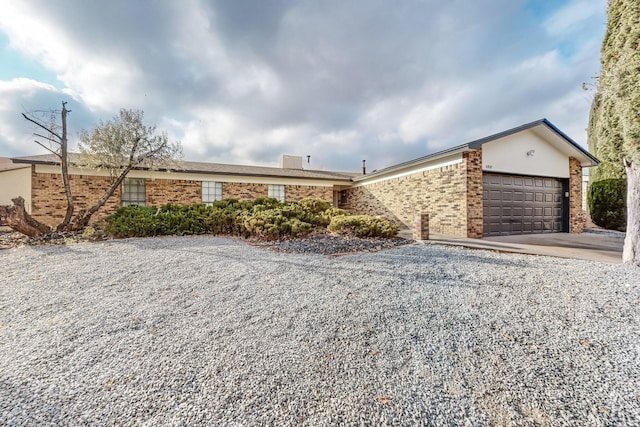 4807 Parsifal St NE, Albuquerque, NM 87111 - ranch-style home with driveway, brick siding, and a garage