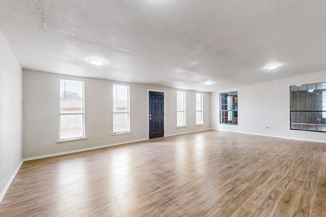 4807 Parsifal St NE, Albuquerque, NM 87111 - unfurnished living room with wood finished floors and a textured ceiling