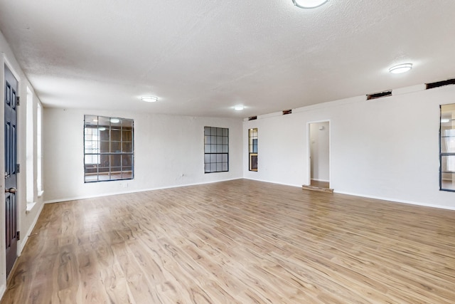4807 Parsifal St NE, Albuquerque, NM 87111 - spare room with light wood-style flooring and a textured ceiling