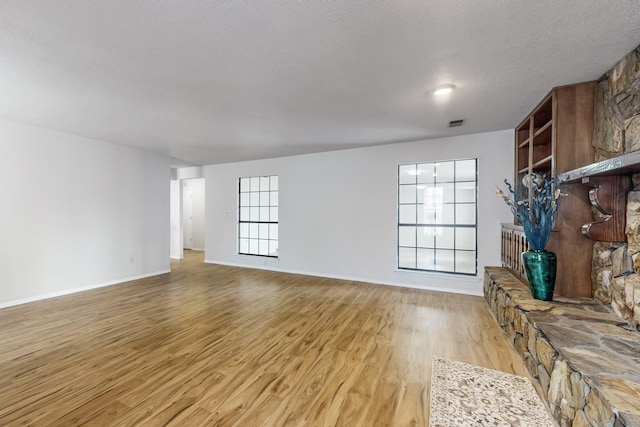 4807 Parsifal St NE, Albuquerque, NM 87111 - unfurnished living room with light wood-style floors and a textured ceiling