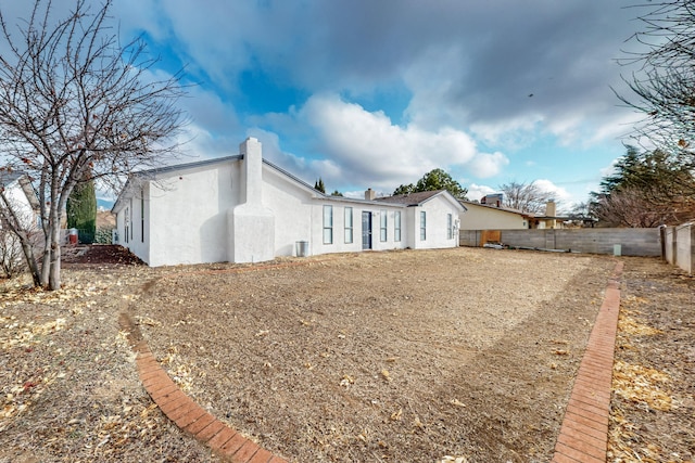 4807 Parsifal St NE, Albuquerque, NM 87111 - back of property featuring stucco siding, a fenced backyard, and a chimney
