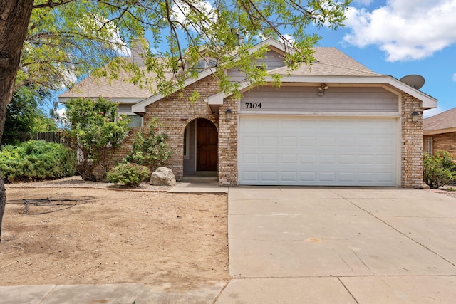 7104 Sunrose Dr NW, Albuquerque, NM 87120 - view of front of house with brick siding, concrete driveway, and roof with shingles