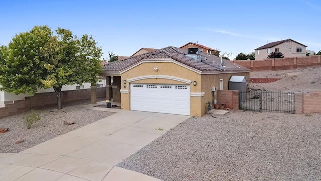 5443 Reserve Ct NE, Rio Rancho, NM 87144 - view of front of property featuring a tiled roof, concrete driveway, stucco siding, a garage, and a gate